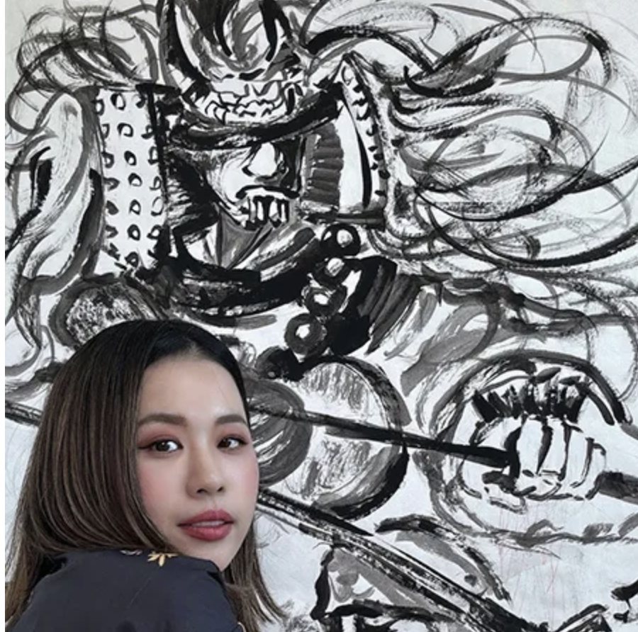 Yoshimi Inoue in front of her sumie painting